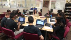 A classroom of high schoolers working on computers